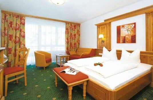 Guest bedroom with king bed and separate seating area