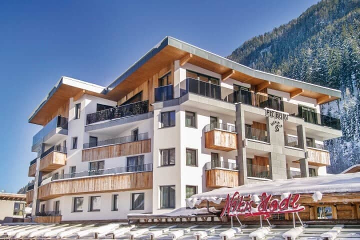 Multi-story chalet with private balconies and mountain backdrop