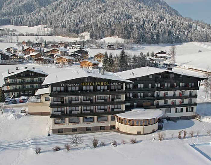 Hotel exterior featuring on-site restaurant and private balconies with mountain views