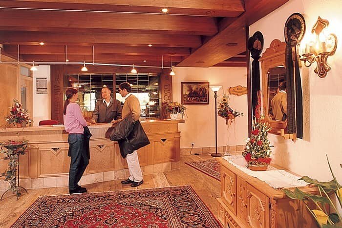 Lobby reception desk with 24-hour staff and exposed timber ceilings
