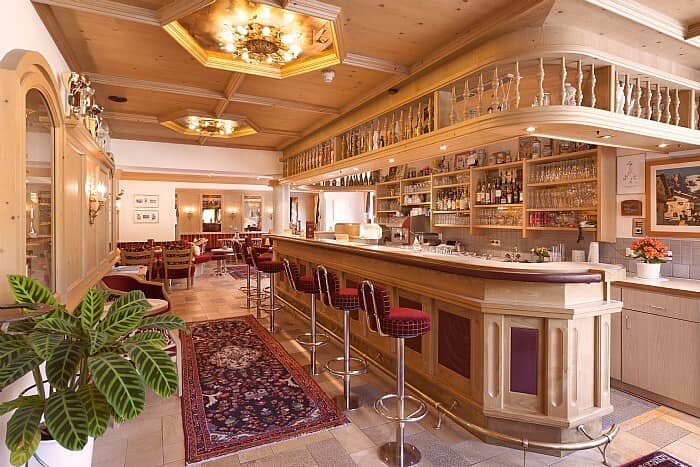 Traditional timber bar with seating for five and adjacent dining area