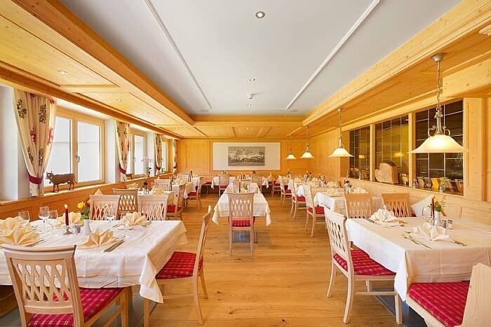 Dining room with pine paneling and seating for over 30 guests
