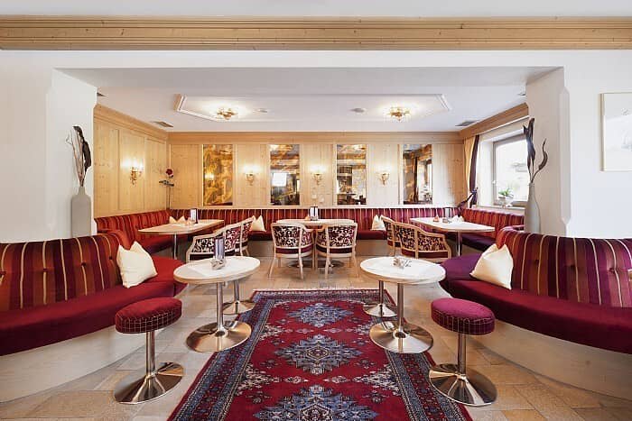 Shared lounge area with booth seating and traditional wood paneling