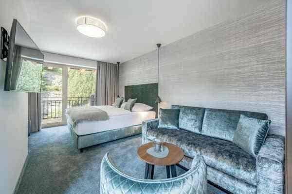 Studio suite with king bed, sofa seating, and private balcony access