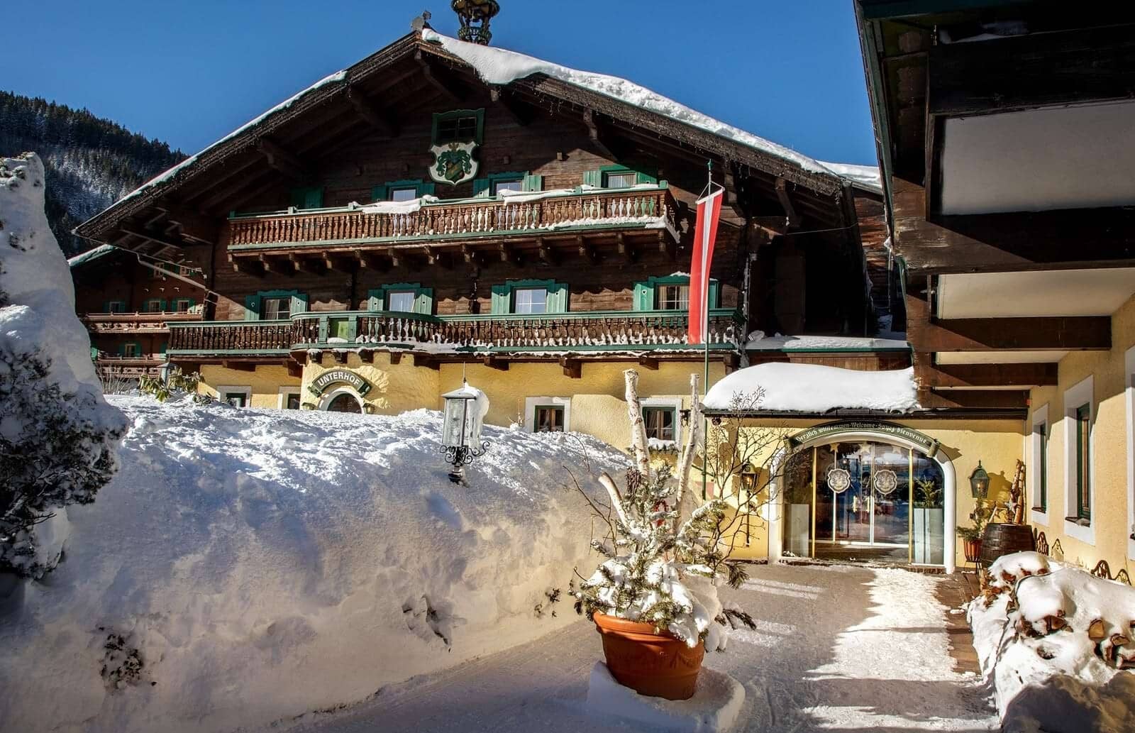 Chalet exterior with tiered timber balconies and traditional green shutters