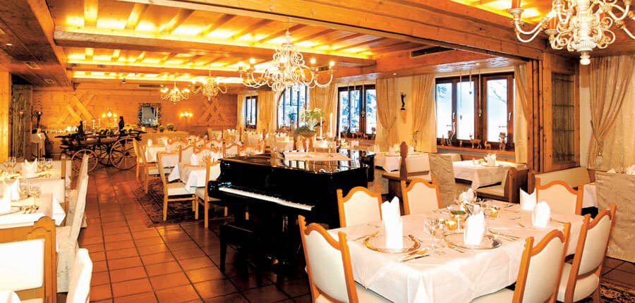 Dining room with grand piano and seating for large groups