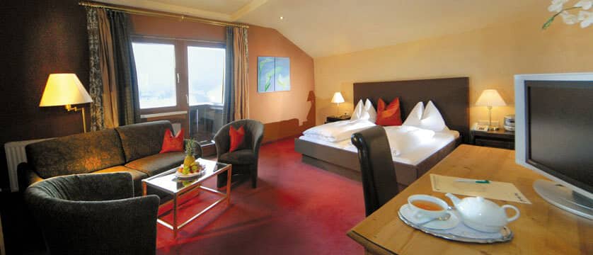 Bedroom featuring king bed, integrated sitting area, and balcony access