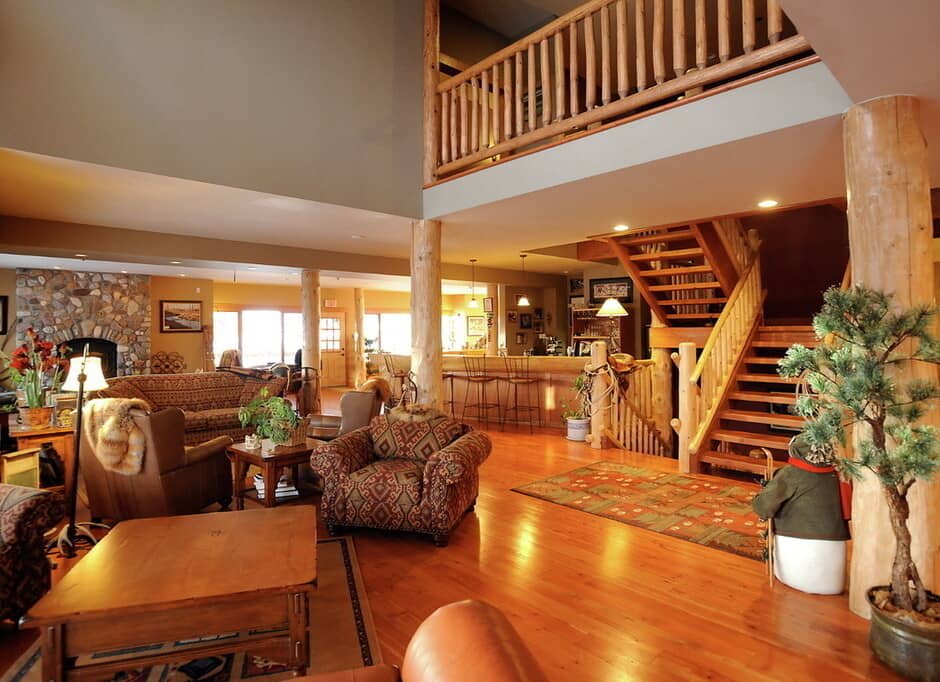 Open-plan living area with stone fireplace and breakfast bar seating