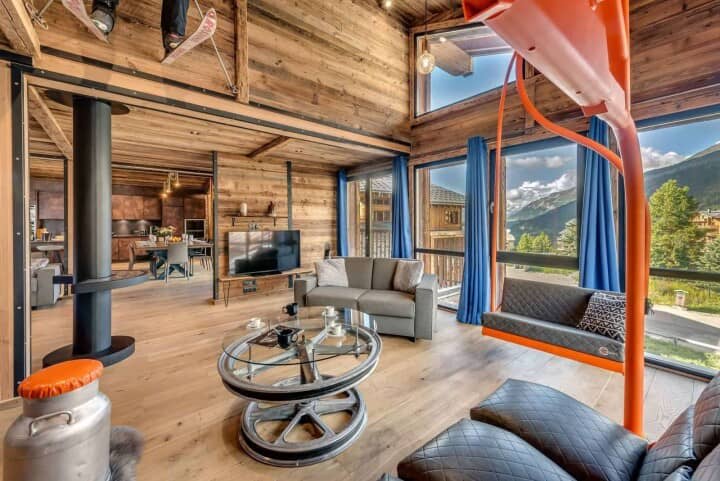 Living area with wood-burning stove and indoor ski lift swing chair