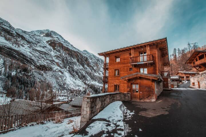 Timber chalet exterior with private balconies and direct mountain views