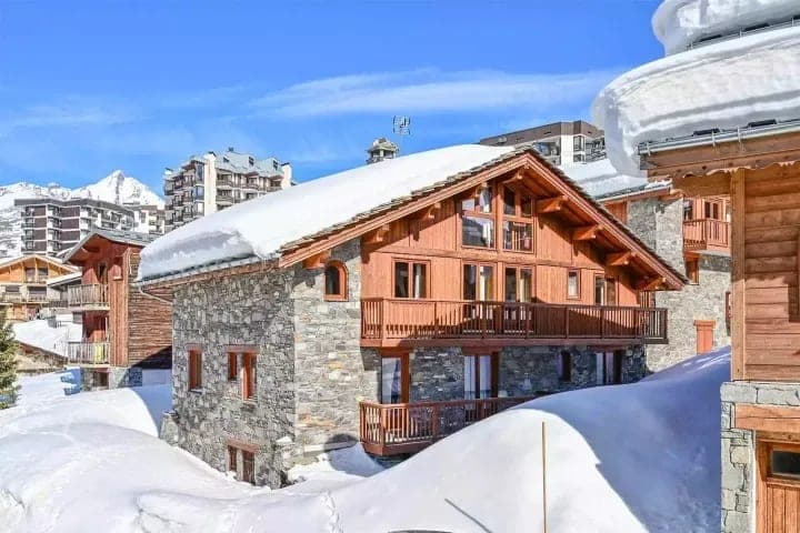 Ski-in/ski-out chalet exterior with private balconies and mountain views