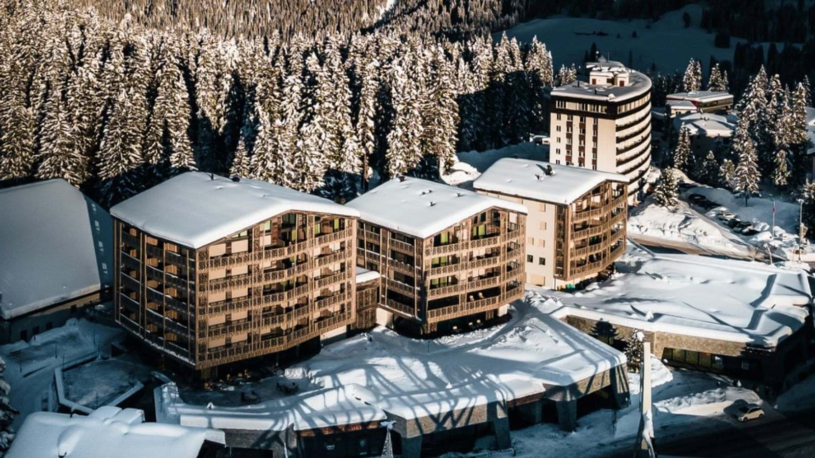 Ski-in/ski-out resort complex with private balconies and forest backdrop