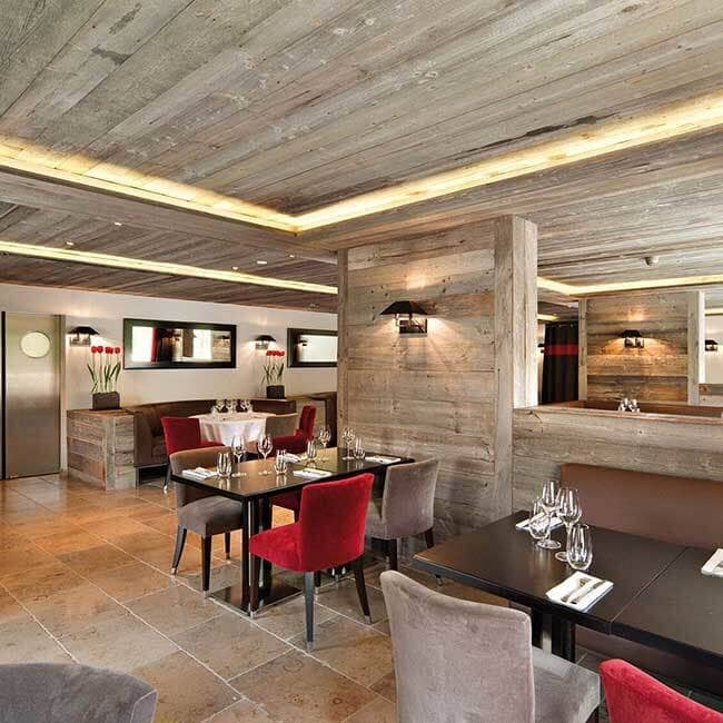Dining room with reclaimed wood walls and limestone tile floors
