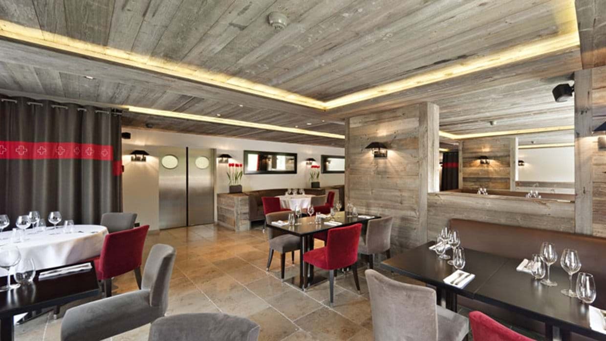 Dining room with reclaimed wood walls and integrated cove lighting