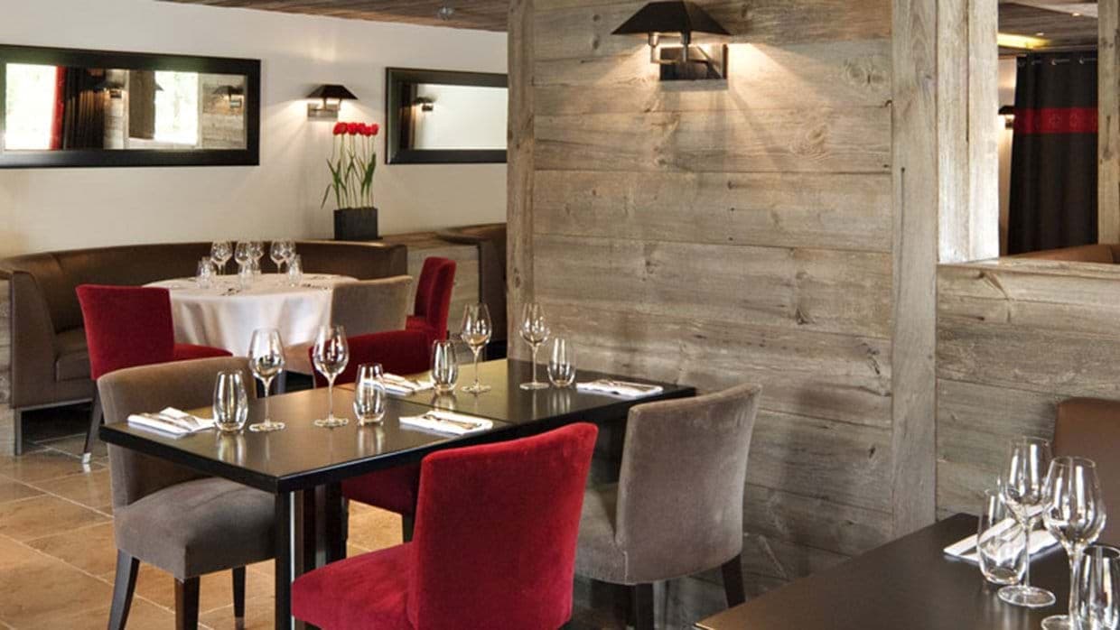 Dining area featuring booth seating and reclaimed wood accents