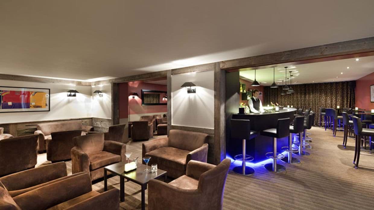 Private lounge and bar with armchairs and LED-lit cocktail counter