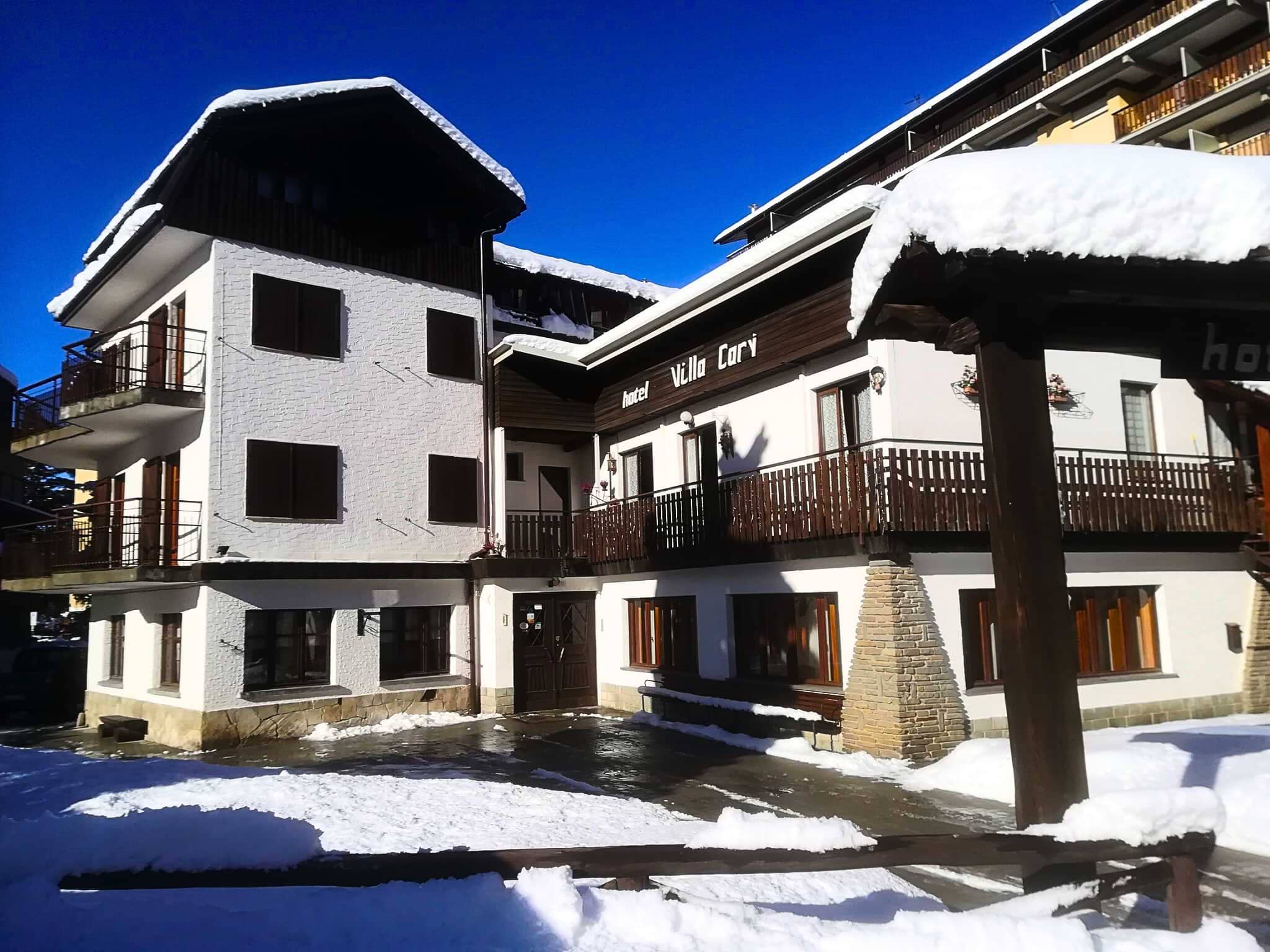 Chalet exterior with private balconies and snow-cleared entryway