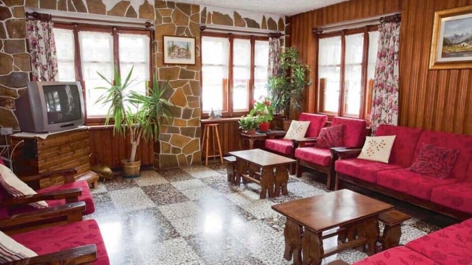 Living area with stone accent walls and seating for at least 8 guests