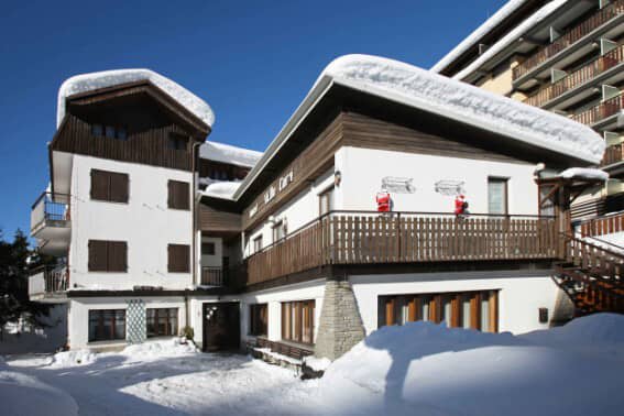 Chalet exterior with ground-floor entrance and wrap-around balcony