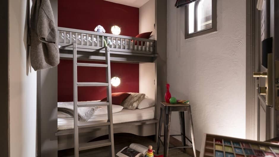 Bunk room with two twin beds and integrated reading lights
