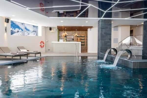 Indoor pool with swan neck water features and poolside juice bar