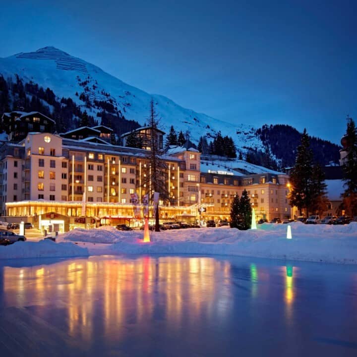 Hotel exterior with private ice rink and mountain views