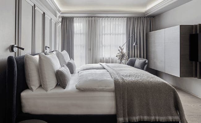 Bedroom with king bed, reading lights, and blackout curtains