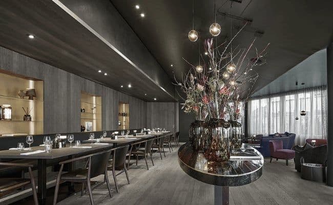 Dining room with integrated banquette seating and adjacent lounge area