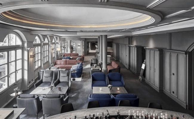 Lounge area with multiple seating clusters and architectural dome ceiling