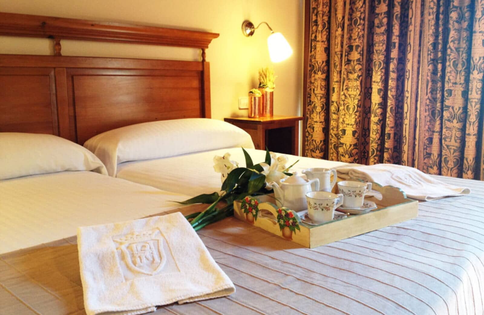 Twin beds pushed together to form king; bedside reading lamp