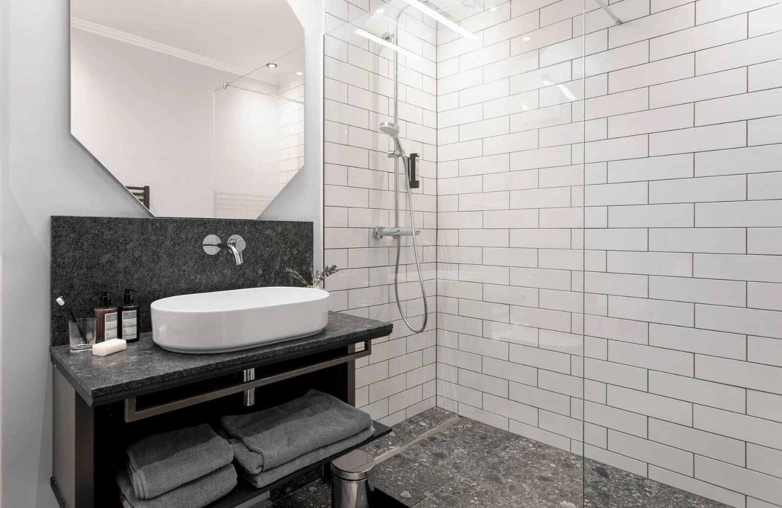 Bathroom with walk-in rainfall shower and stone-top vanity