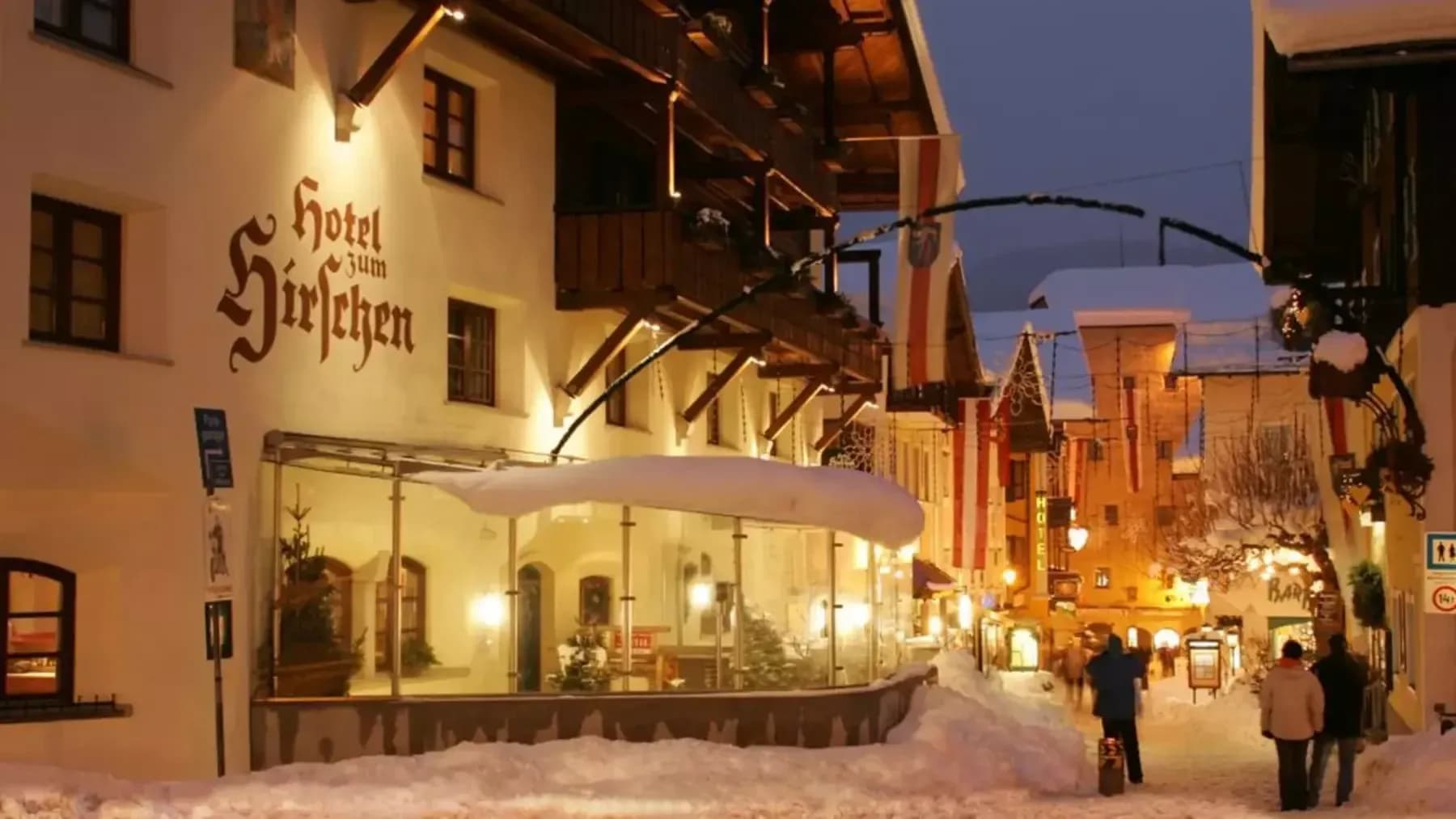 Hotel exterior entrance within pedestrian-only village center with snow-covered streets