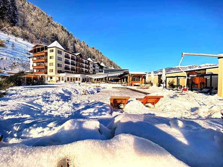 Ski-in/ski-out resort terrace with heated pool and mountain views