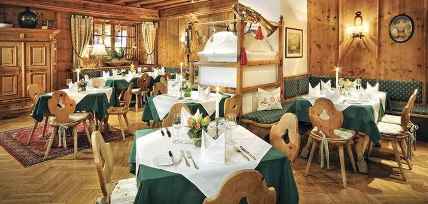 Dining room with traditional wood paneling and masonry heater