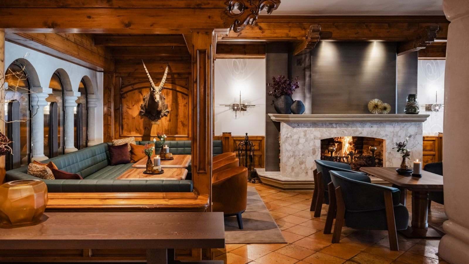 Lounge with wood-burning stone fireplace and built-in booth seating