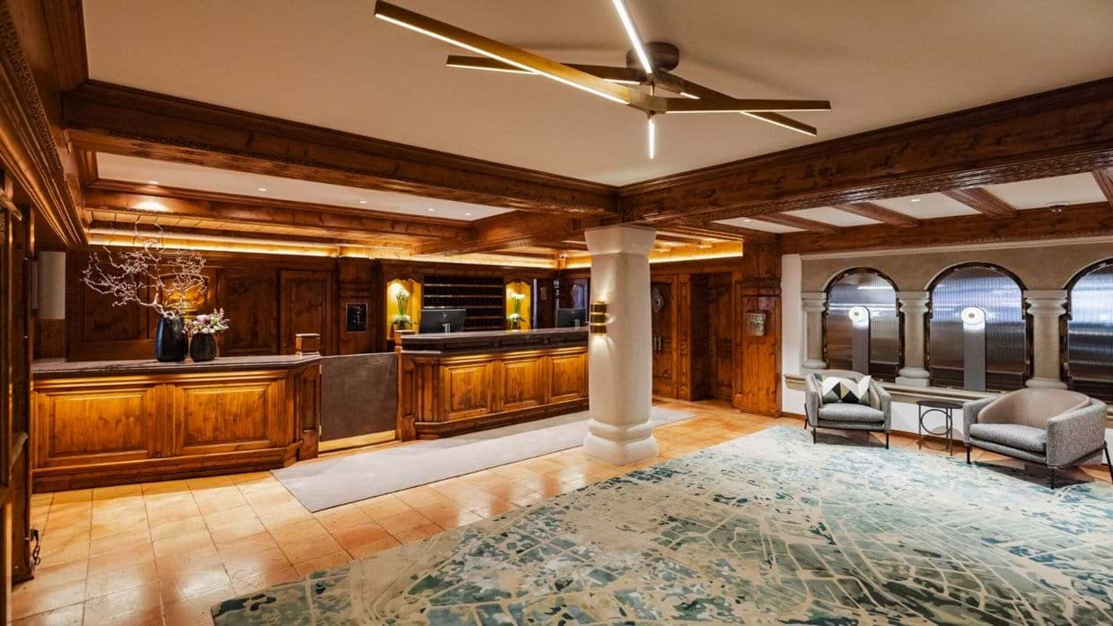 Reception lobby with wood paneling and arched window seating area