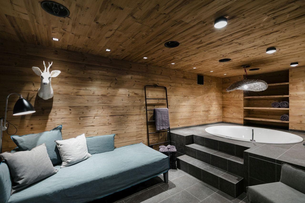 Spa room with sunken soaking tub and integrated sound system