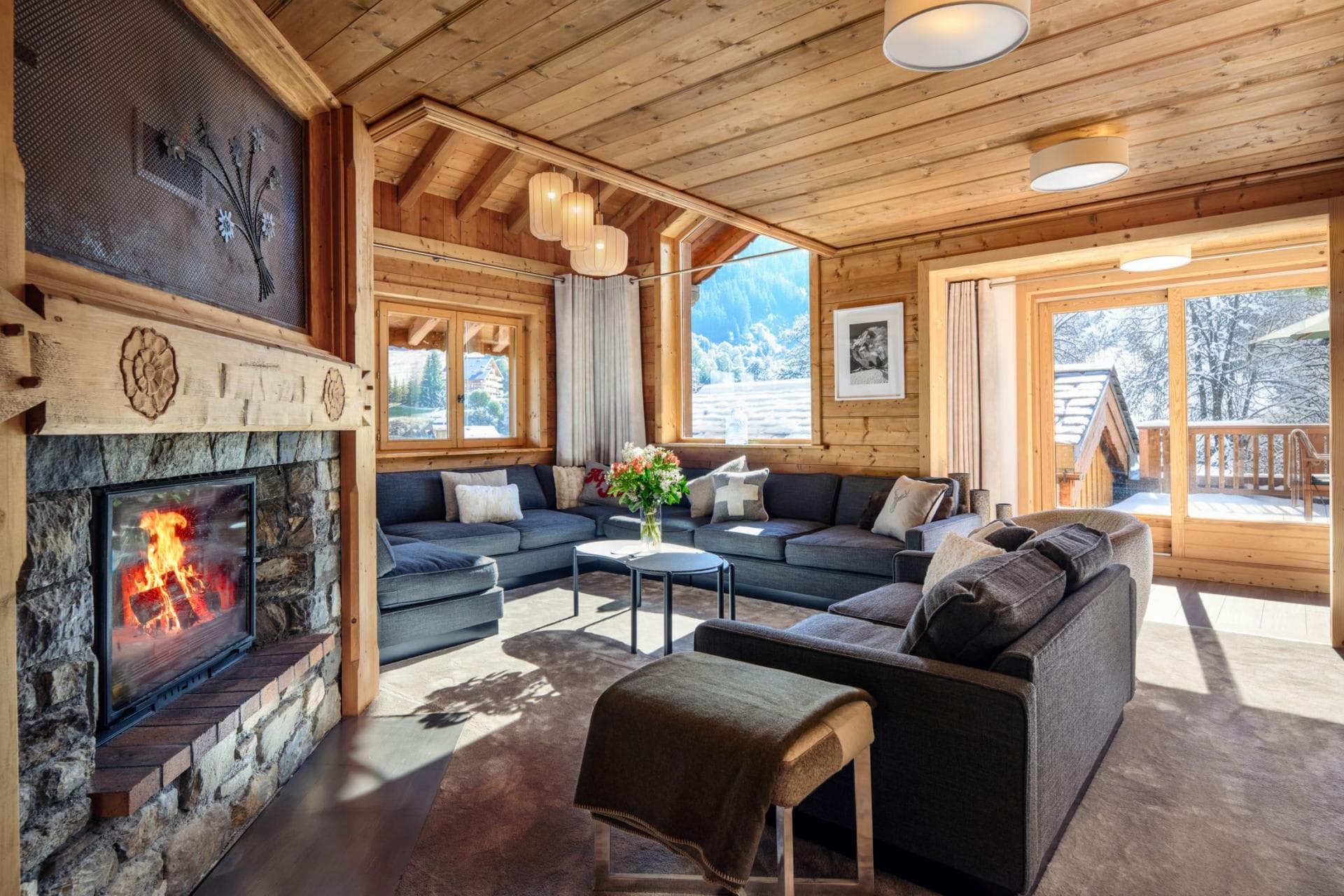 Living area with stone fireplace and sectional seating for 10 guests