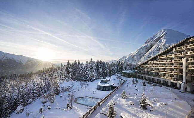 Ski-in/ski-out resort exterior with heated outdoor pool and mountain views