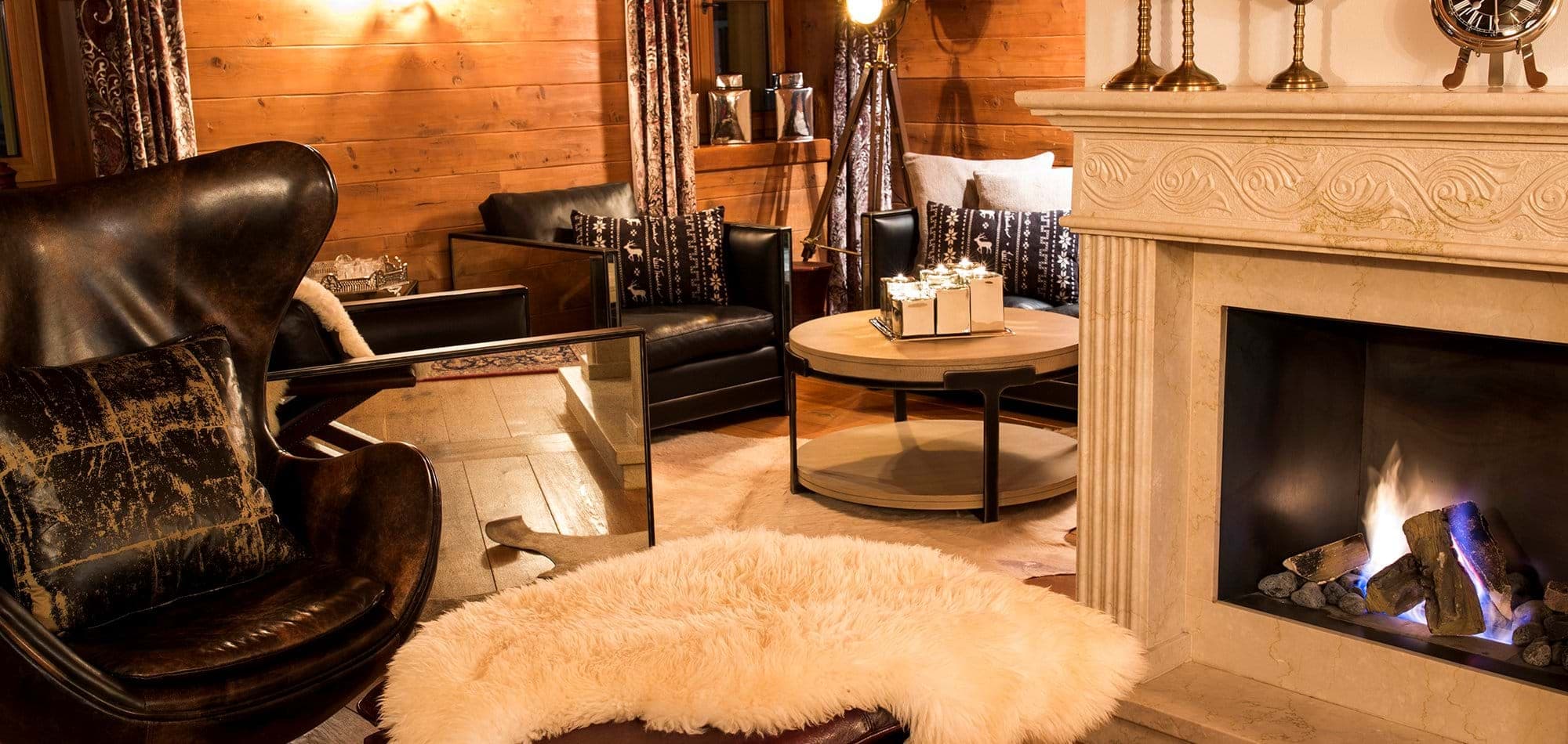 Living area with wood-burning fireplace and leather armchair seating