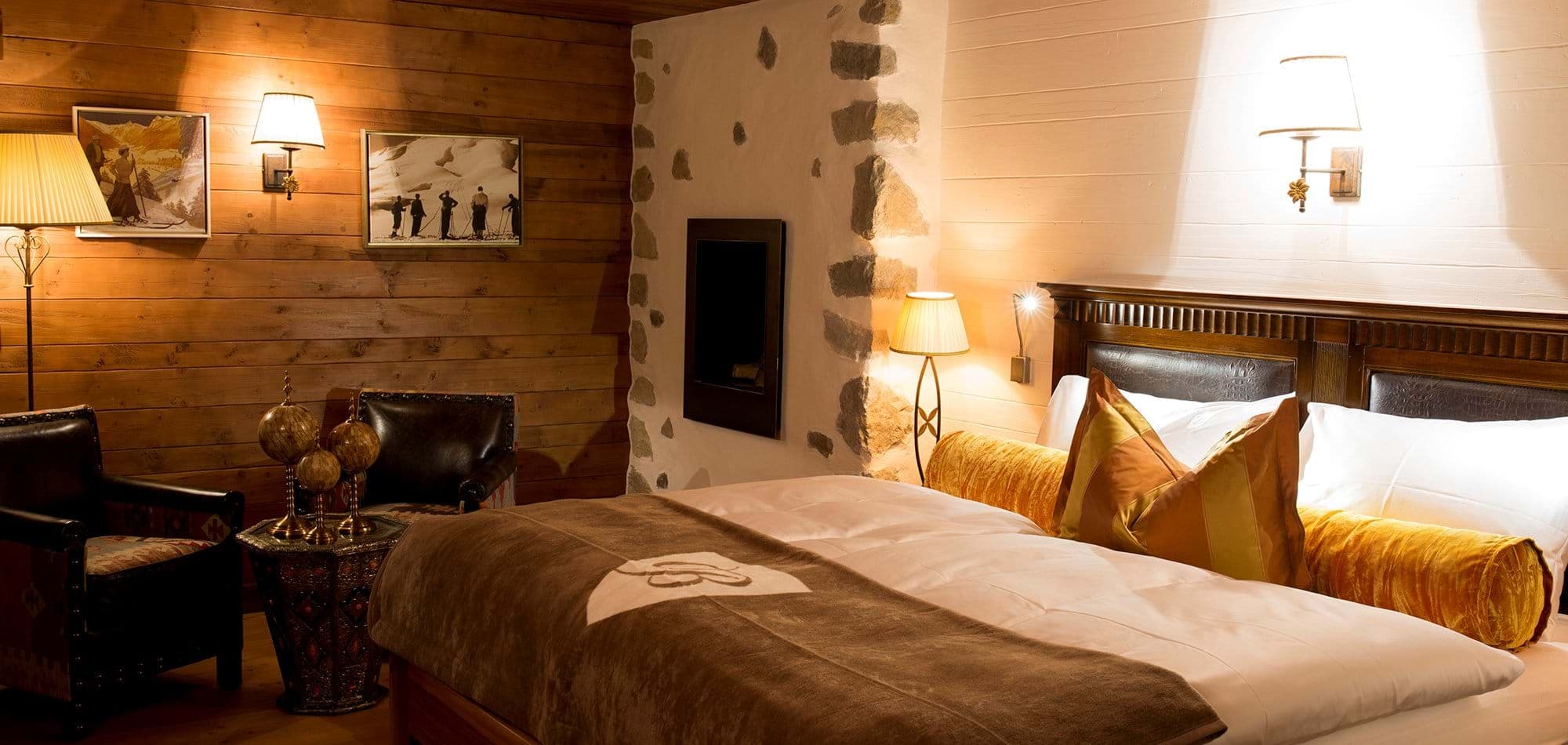 Bedroom with gas fireplace, seating area, and individual reading lights