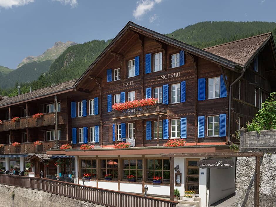 Traditional chalet exterior with private balconies and mountain views