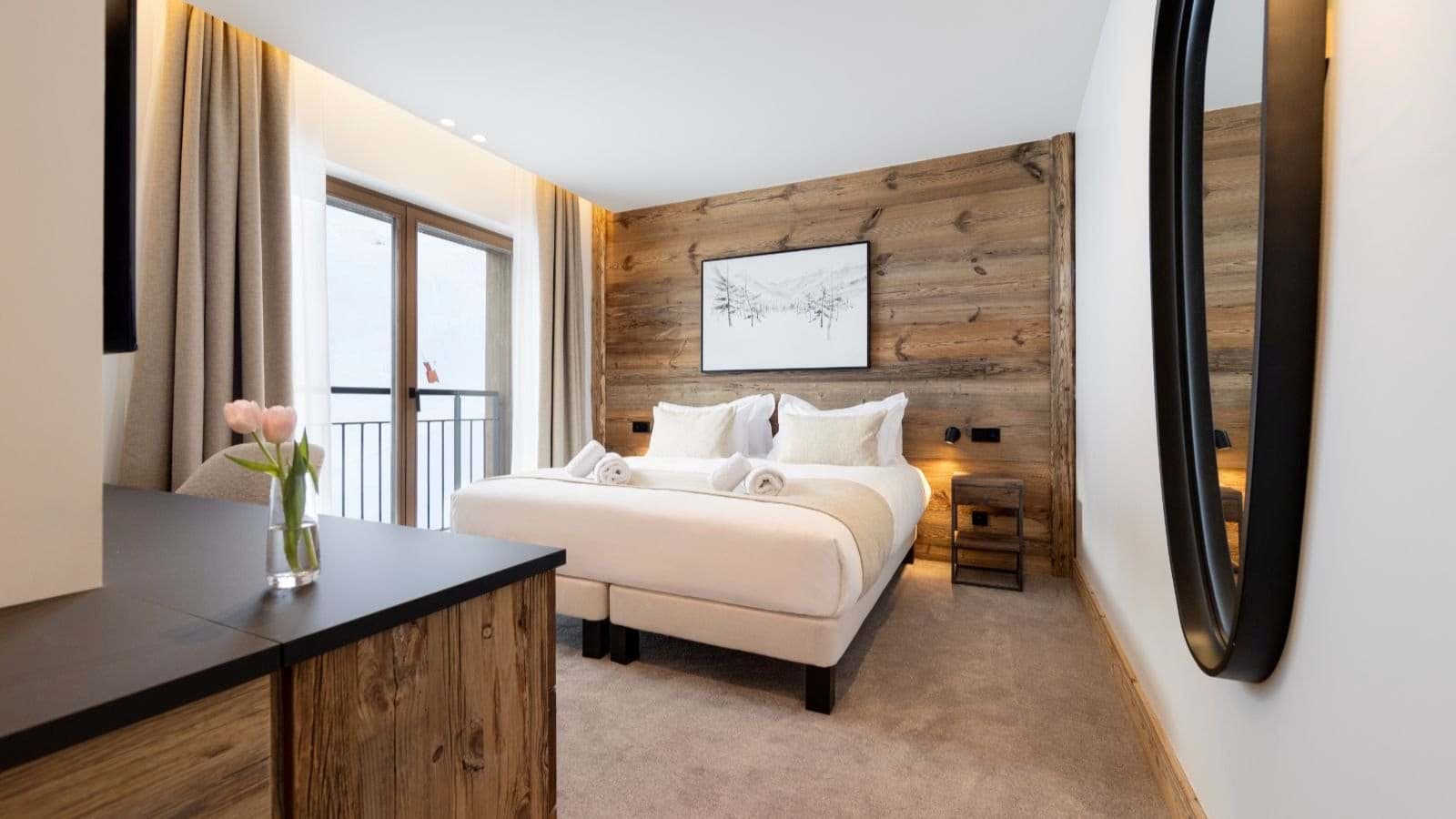 Guest bedroom with convertible twin-to-king bed and private balcony access