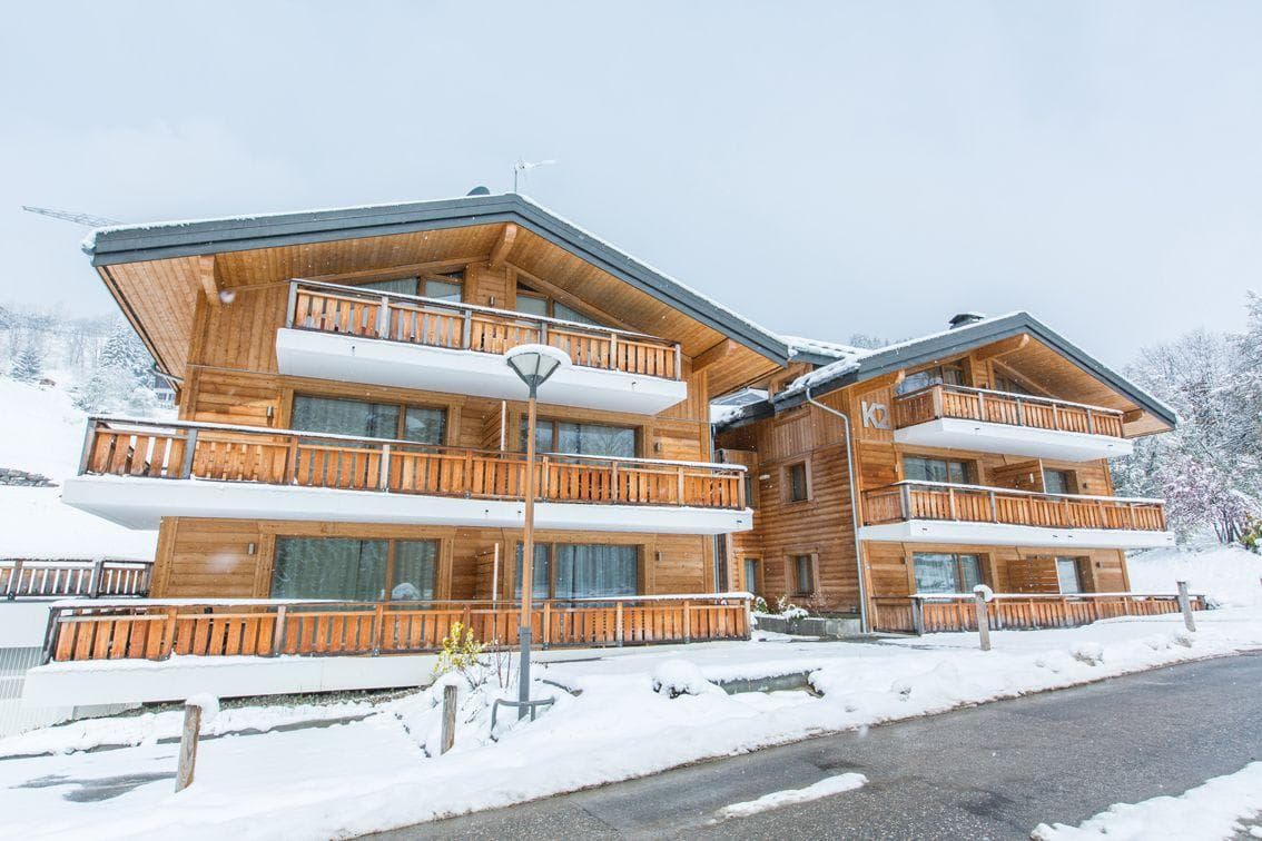 Ski-in chalet exterior featuring private balconies and designated underground parking