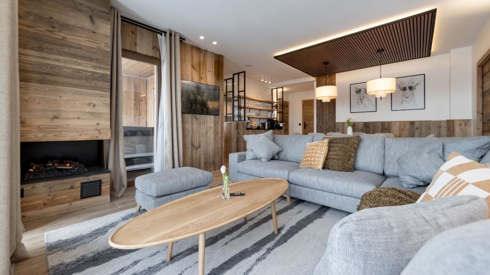 Living area with electric fireplace and adjacent balcony access