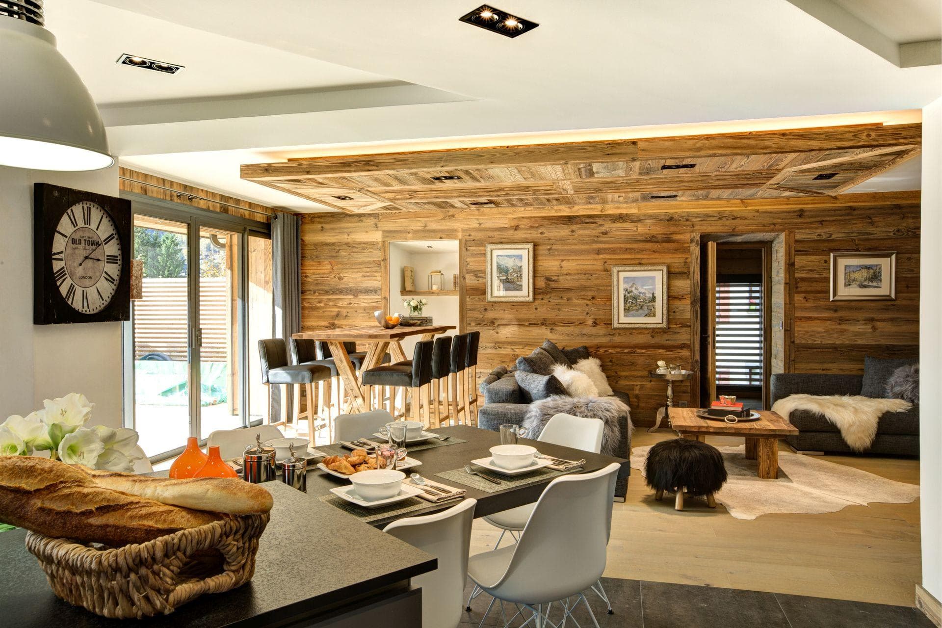 Open-plan living area with reclaimed wood walls and sliding terrace doors