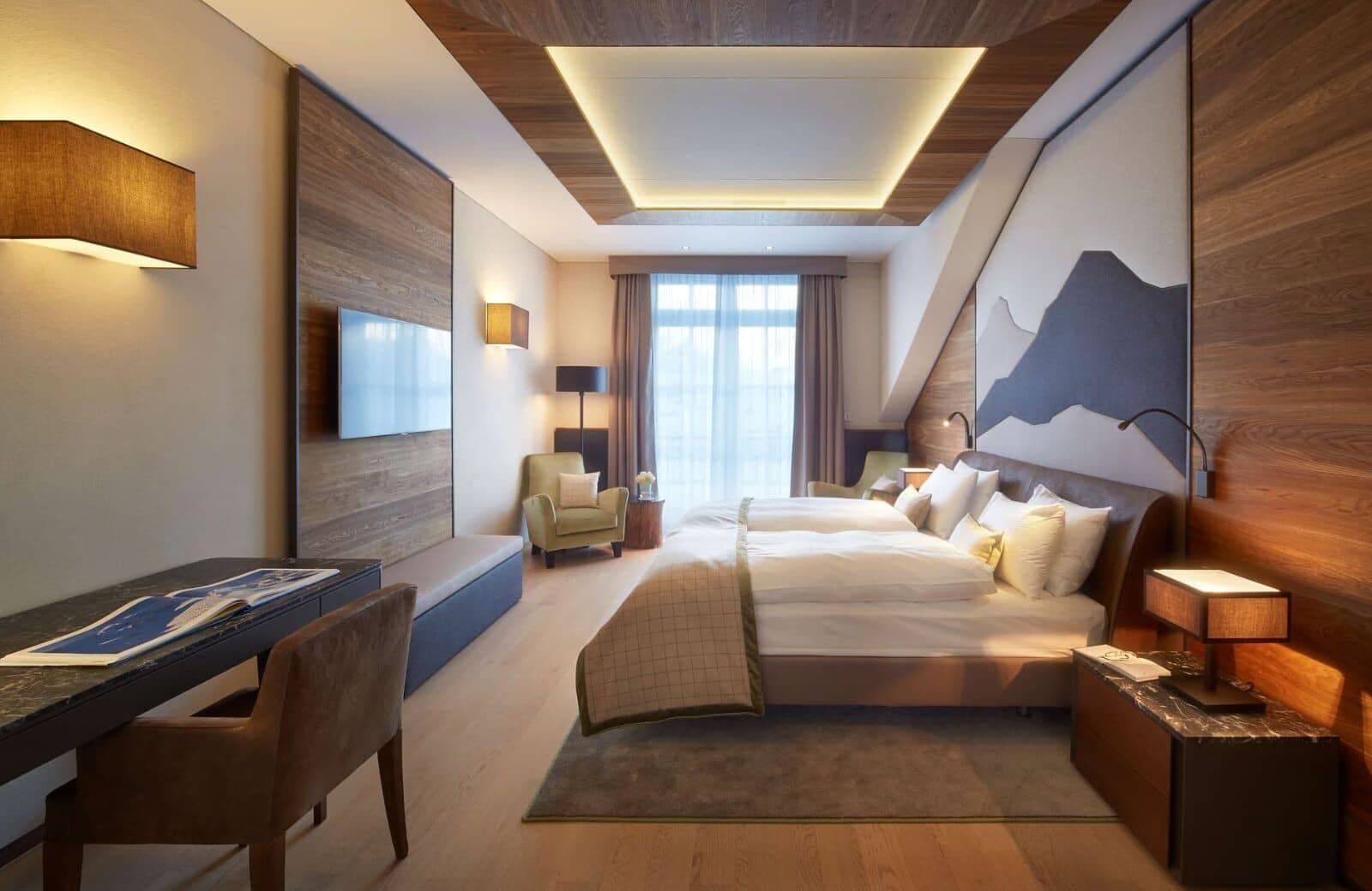 Guest bedroom with two twin beds, workspace, and integrated reading lights