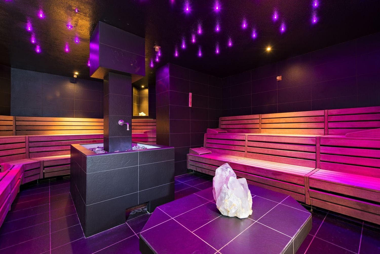 Large cedar sauna with tiered seating and fiber optic star ceiling