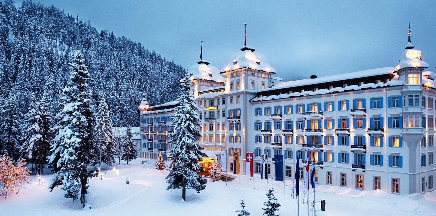 Ski-in, ski-out resort exterior with forest backdrop and alpine architecture