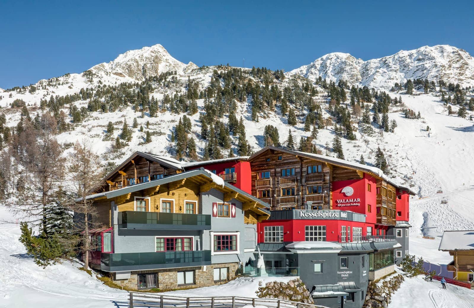 Ski-in/ski-out hotel exterior with direct access to groomed mountain runs